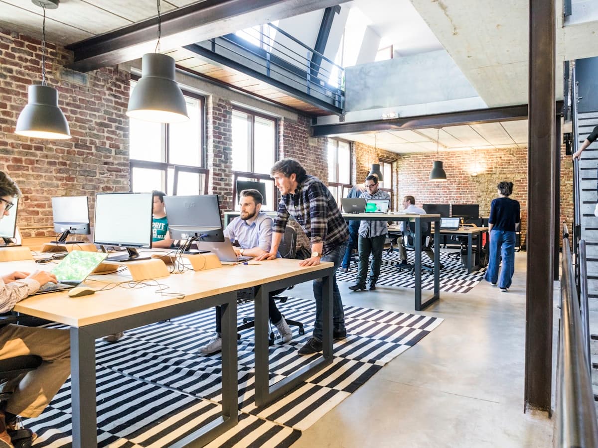 A daylit workspace with long shared desks